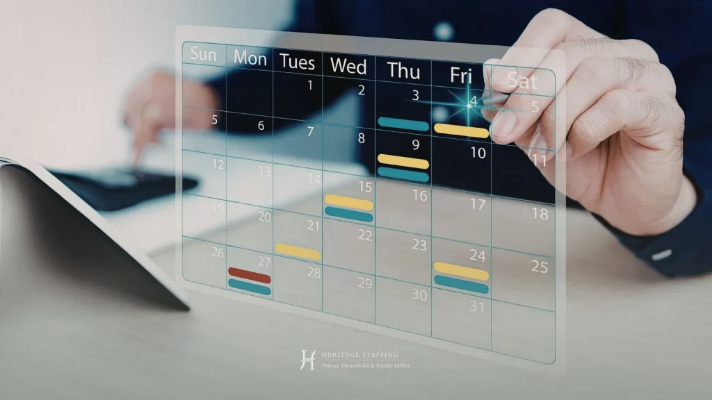 Hand interacting with a digital calendar interface above a tablet in an office setting.