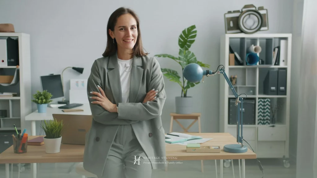 professional standing confidently in office with arms crossed, representing leadership gap between personal assistant and chief of staff roles
