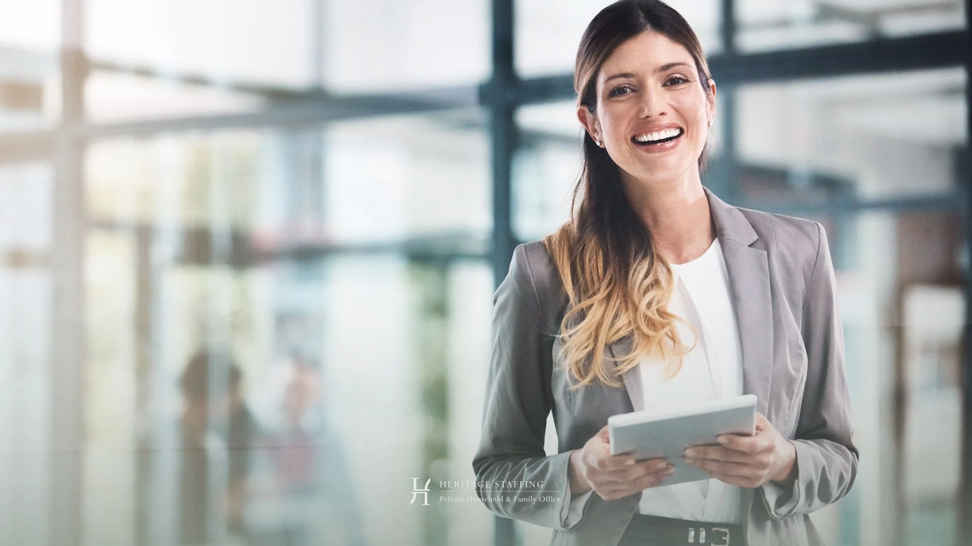 Professional executive assistant holding tablet illustrating transition from corporate EA to private PA role