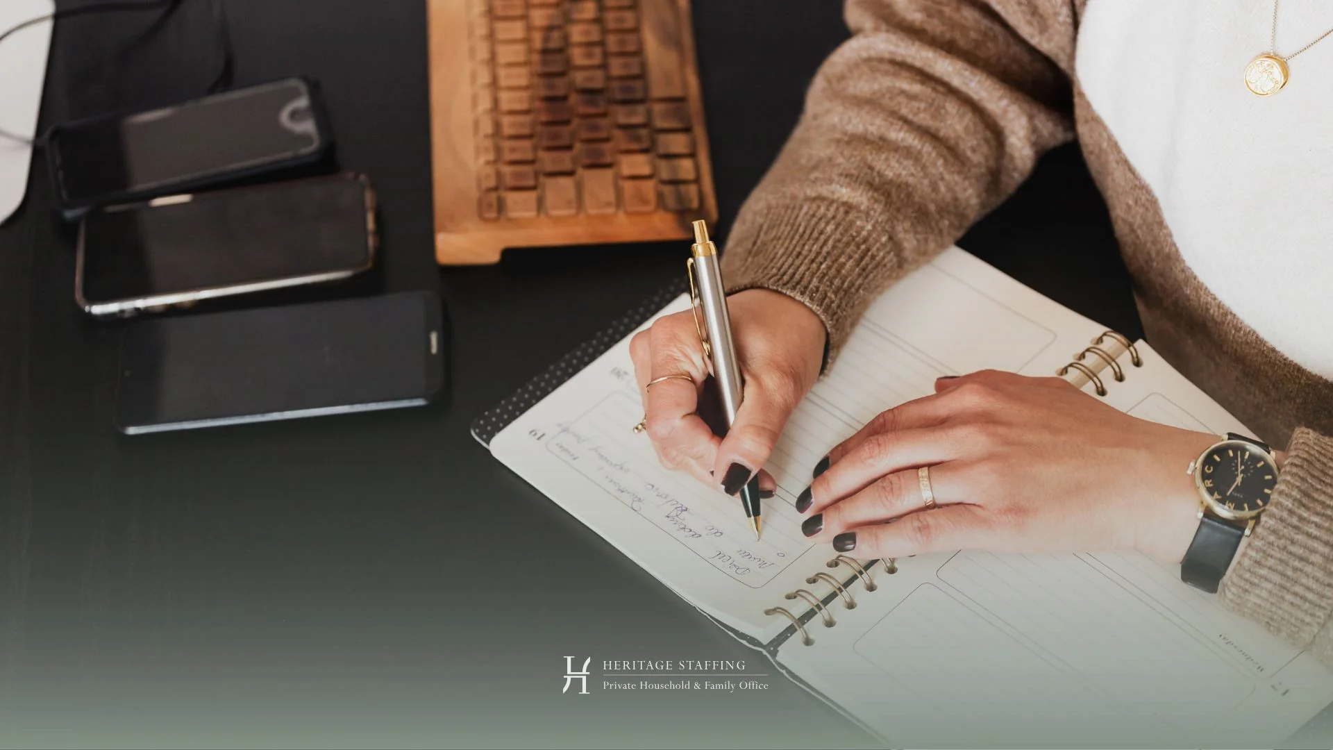 professional writing in planner with devices nearby, illustrating executive calendar management and time optimization strategies
