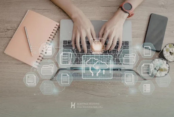 hands typing on laptop with cloud and data icons overlay, representing digital systems replacing legacy knowledge in estate management