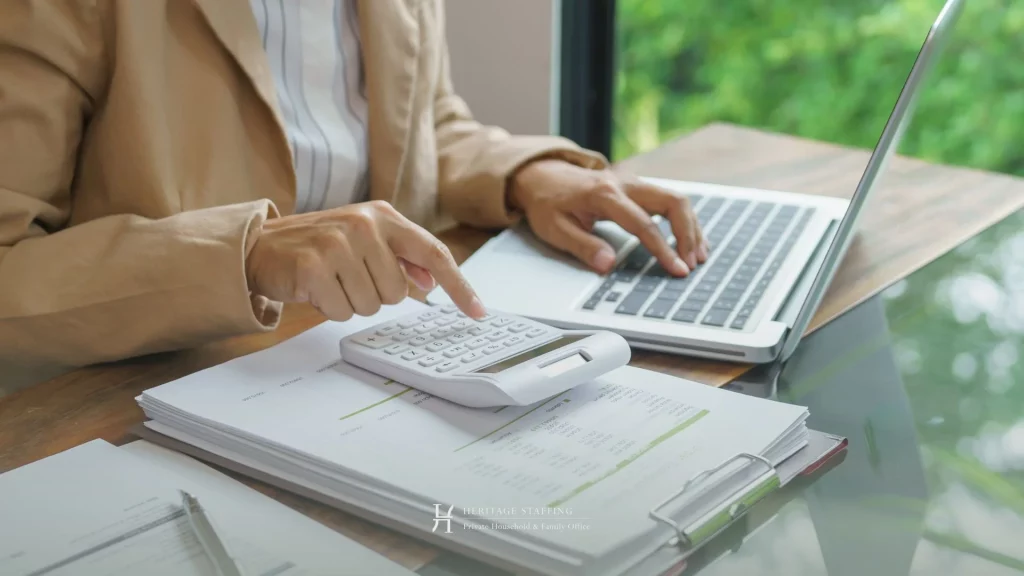 Professional reviewing financial documents and using calculator for SFO vs MFO cost comparison in Switzerland