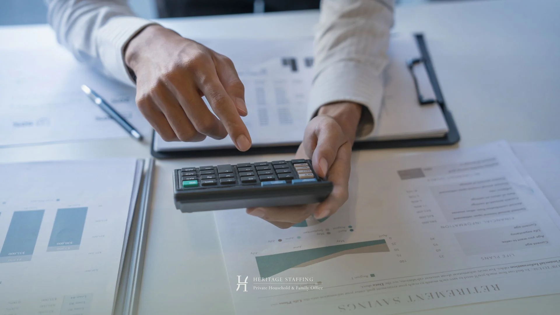 Close-up of hands using calculator over financial reports illustrating cost analysis for SFO vs MFO in Switzerland