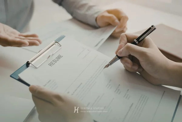 candidate signing resume during a professional interview, illustrating confidentiality protocols in external recruitment for private households