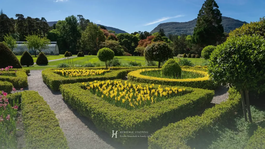 Manicured garden of luxury estate illustrating seasonal property maintenance and staffing needs