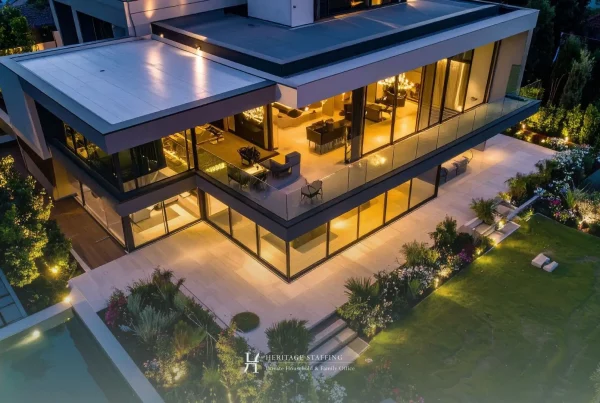 Modern luxury villa at dusk illustrating seasonal home opening and staffing for property maintenance