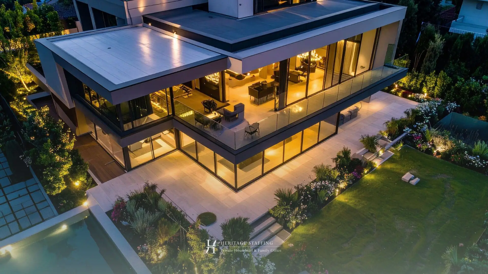 Modern luxury villa at dusk illustrating seasonal home opening and staffing for property maintenance